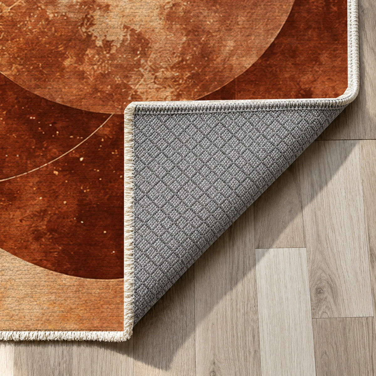 Celestial Orbits Terracotta Abstract Washable Rug — backing close up