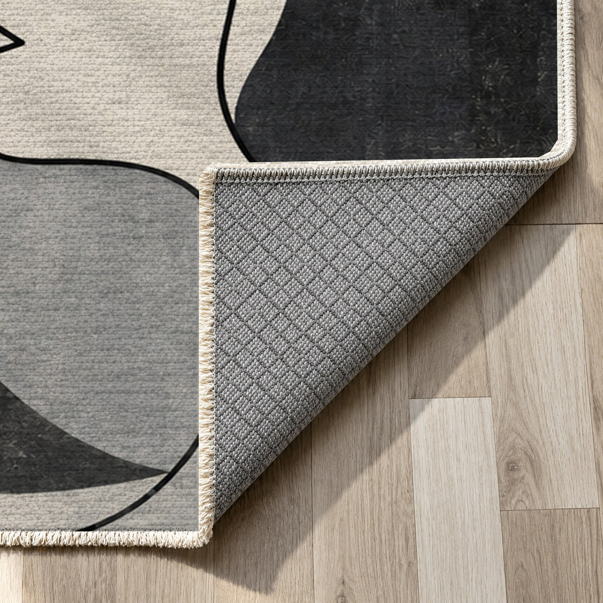 Conversation Charcoal Abstract Washable Rug — backing close up
