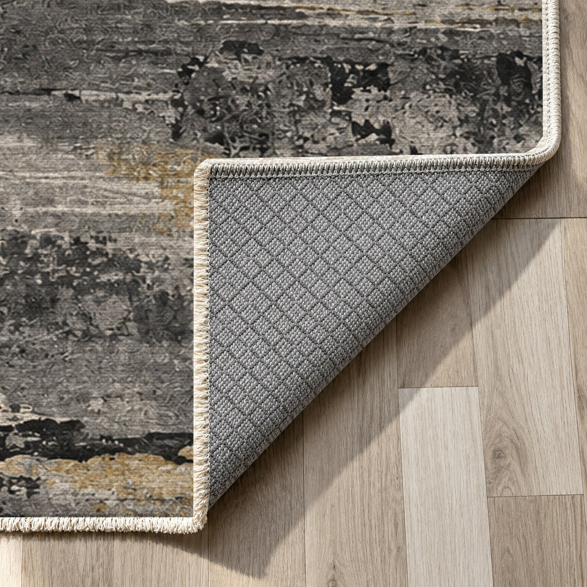 Eroded Strata Charcoal Gold Abstract Washable Rug — backing close up
