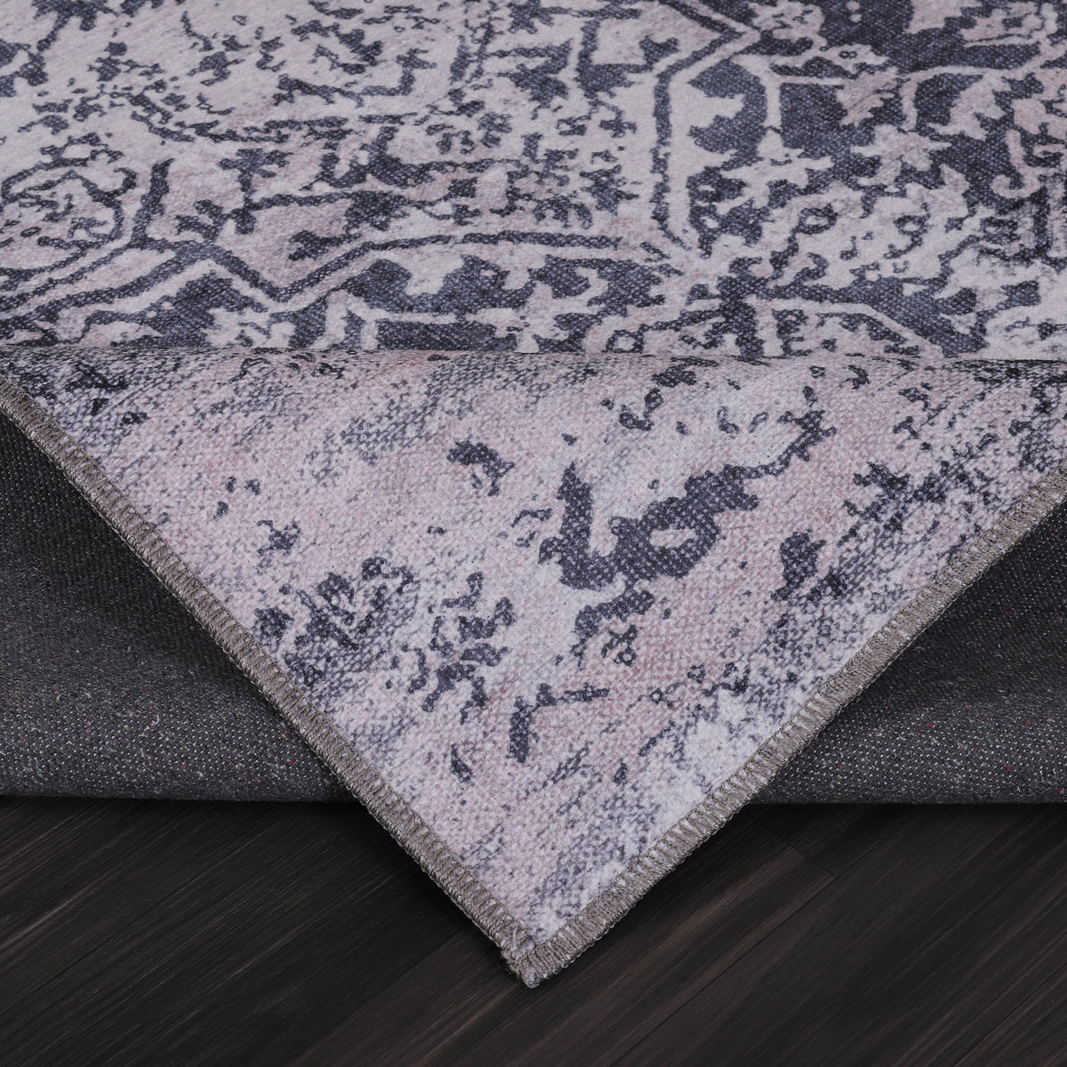Germanica Washable 1338 — washable 1338 charcoal grey distressed medallion folded corner close up rug 18
