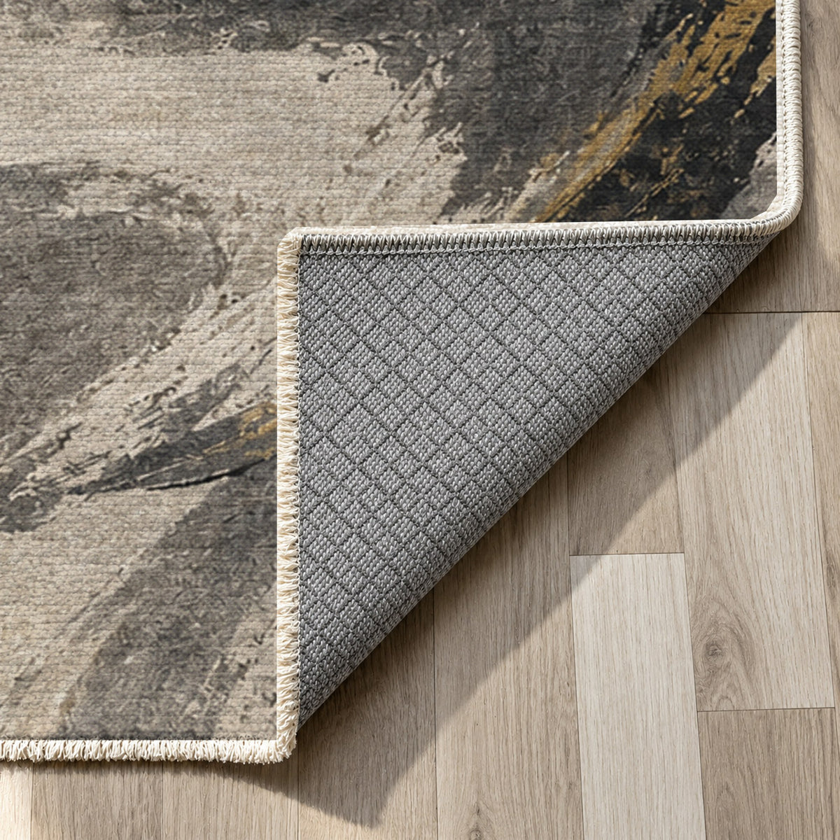 Wind Script Charcoal Gold Abstract Washable Rug — backing close up